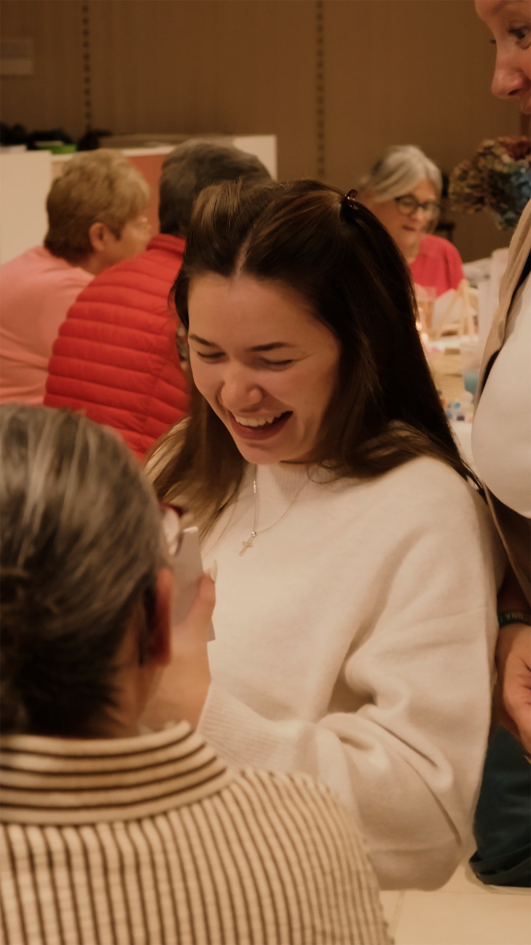 A woman laughing at an Anchor Ladies event